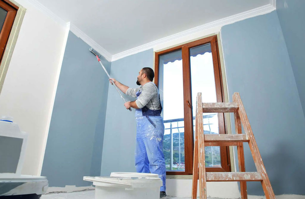 Spotless interior painting job site with covered floors and wrapped furniture